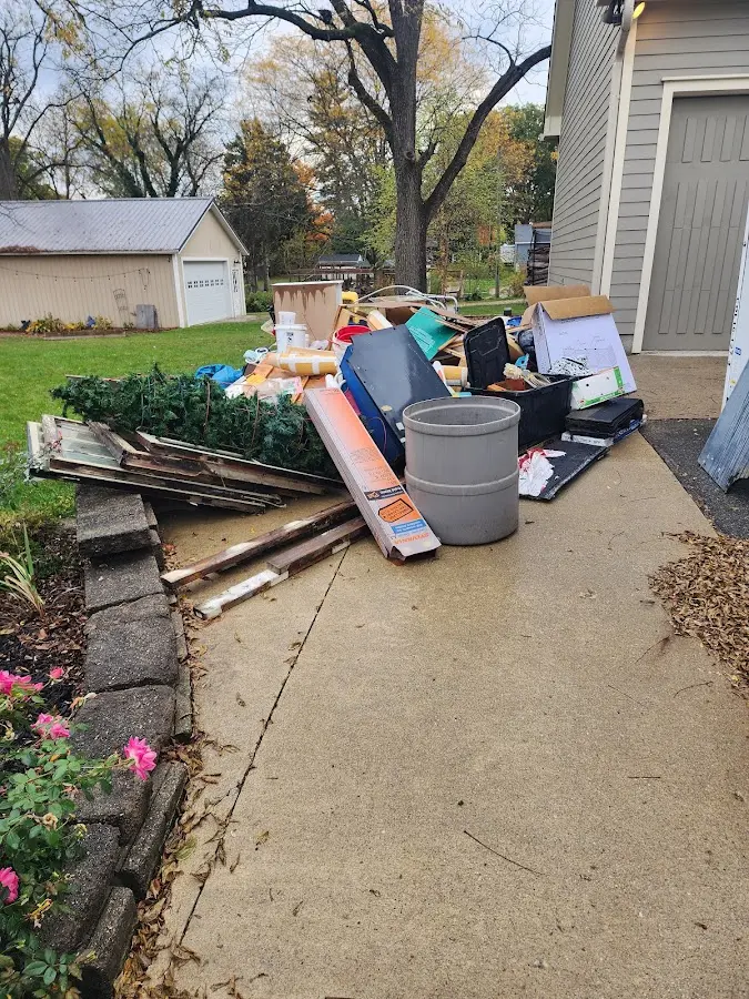 Dumpster being loaded with debris for Roofing Dumpster Rental in Sanford